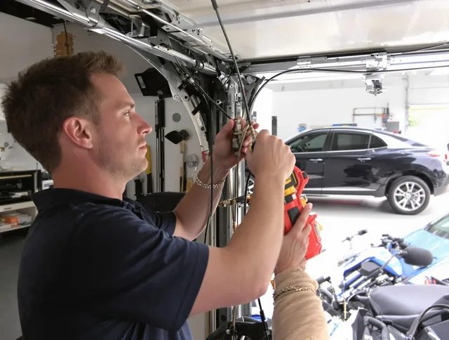 Security-Widefield Garage Door Repair safety certified technician performing cable replacement in Security-Widefield